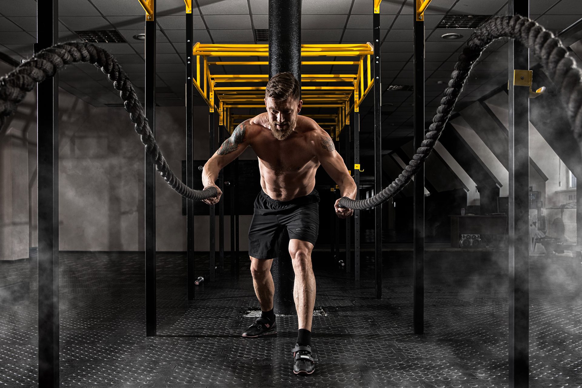 rss male athlete battle ropes gym training