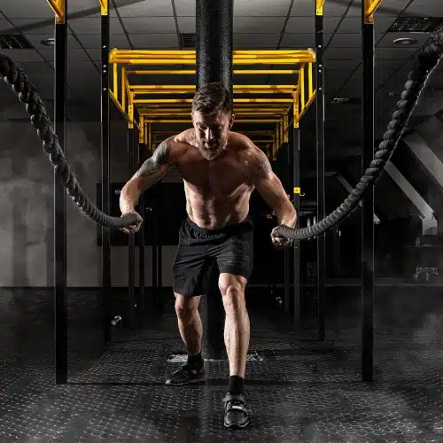 rss male athlete battle ropes gym training